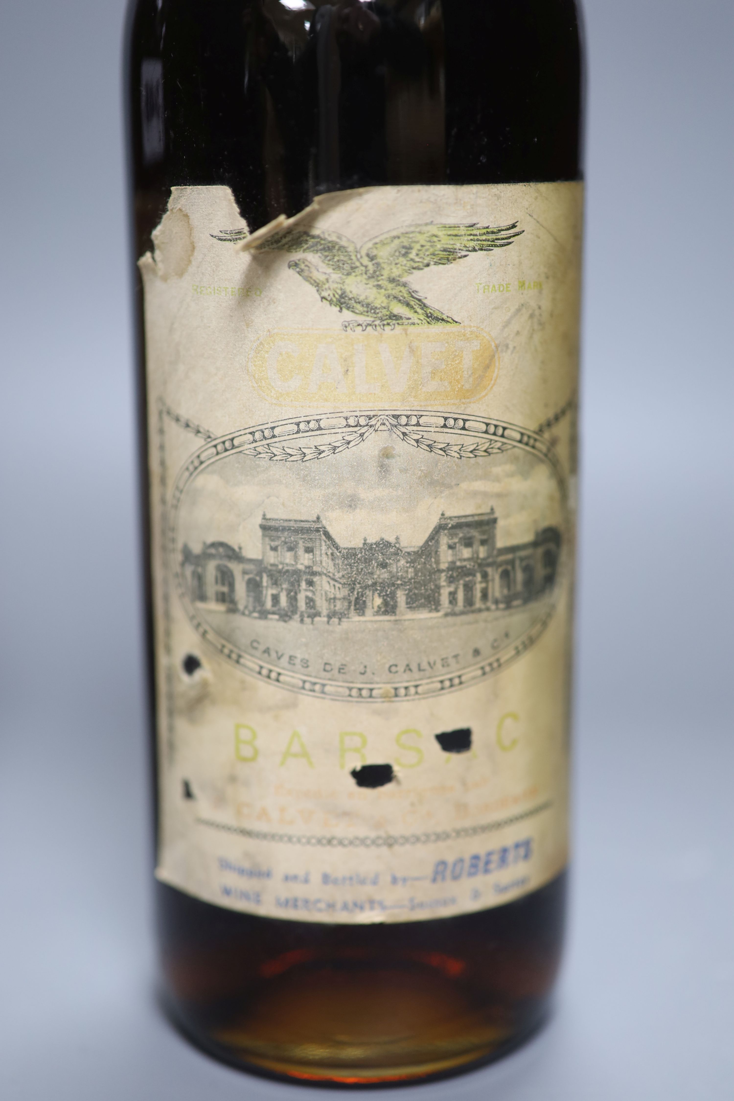 A 1915 bottle of Heidsieck, a bottle of Barsac and a K.P. Charente brandy by Peters Hall & Co, London